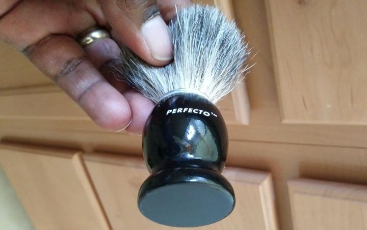 Using the black travel shaving brush from Perfecto